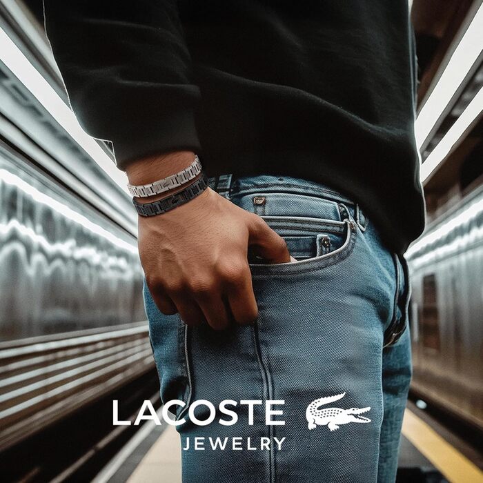 Спортивний браслет Lacoste Metropole сріблястого кольору з візерунком petit piqué та застібкою-затискачем, унісекс